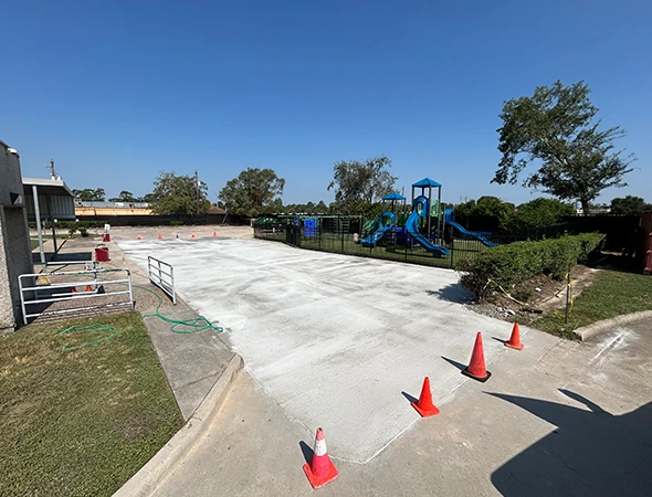 Reinforced concrete slab being poured for commercial parking lot construction